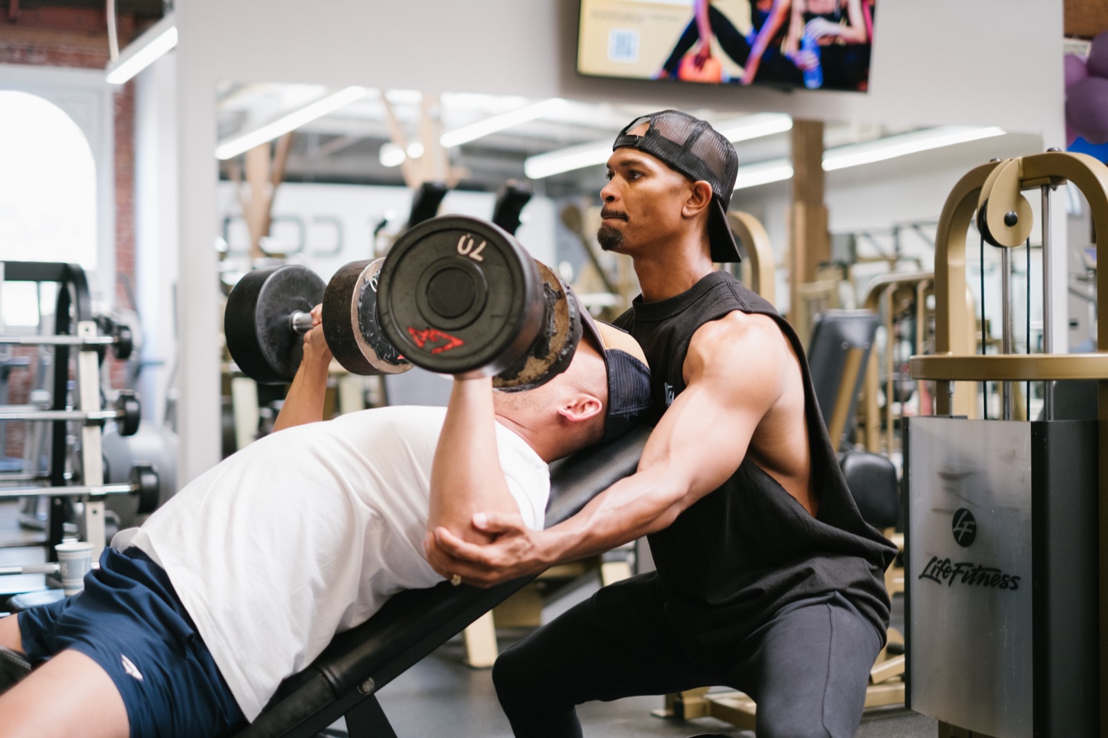 Tory spotting a client on the bench press